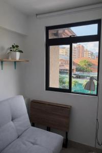 a living room with a couch and a window at Casa hotel Los Laureles in Medellín