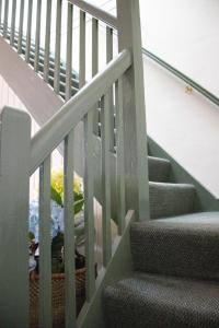 a stairway with a chair and a stair case at 2 Bedroom Self Contained Apartment with Spa in Ballarat +3 photos