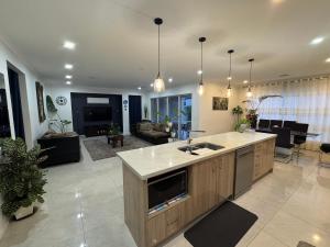 a large living room with a kitchen and a living room at Quiet and Cozy Room in Geelong