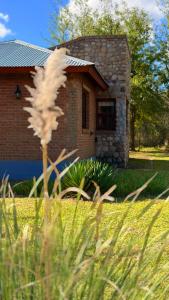 a brick house with a building in the background at El Joaquin in Nono