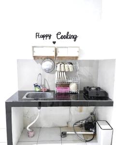 a kitchen counter with a happy cooking sign on it at Ibiza house pangandaran in Pangandaran