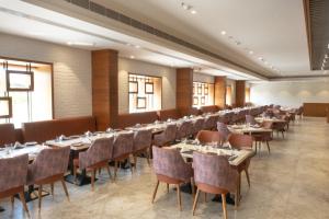 a row of tables and chairs in a restaurant at Radisson Resort & Spa Sasan Gir in Junagadh