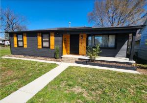a home with a black and yellow house at Ambervine in Lowell
