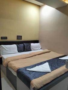 a couple of beds in a room at Coorg point in Madikeri