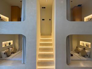 a staircase leading to a bedroom with a mirror at Soma House - Adults Only in Kuta Lombok +75 photos