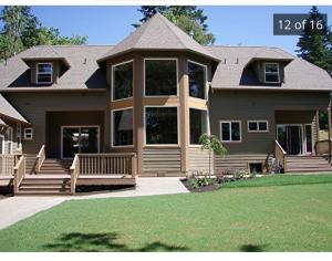 a large house with a large front porch and large windows at Waterfront home in Gig Harbor