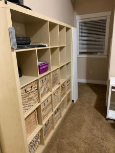 a room with a shelf filled with wine bottles at Waterfront home in Gig Harbor