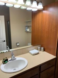 a bathroom with a sink and a large mirror at Waterfront home in Gig Harbor +17 photos