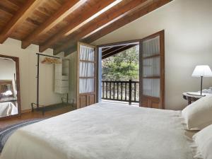a bedroom with a large bed and a large window at Mansion in Nava with Pool & Terrace in Nava +37 photos