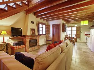 a living room with a couch and a fireplace at Mansion in Nava with Pool & Terrace in Nava