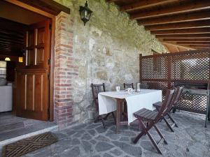 a white table and chairs on a patio at Mansion in Nava with Pool & Terrace in Nava
