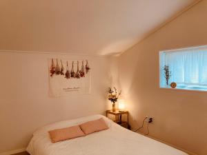 a bedroom with a white bed and a window at Dontan terrace in Hwaseong