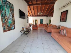 a large living room with couches and a tv at A Serene Get Away in Vieux Fort