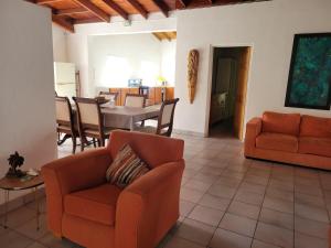 a living room with orange chairs and a table at A Serene Get Away in Vieux Fort