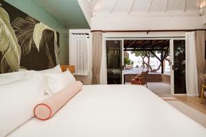 a bedroom with a white bed with a towel on it at Davinia Hua Hin Resort in Hua Hin