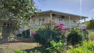 a house with a fence in front of it at A Serene Get Away in Vieux Fort