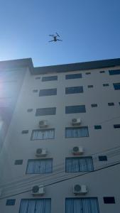 a building with a bird on top of it at Hotel Guia lopes in Santa Rosa