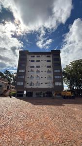 a large white building with a sky in the background at Hotel Guia lopes in Santa Rosa