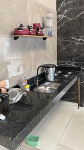 a kitchen with a sink and a counter top at Vista Bela Guesthouse in Barra do Garças