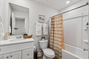 a bathroom with a toilet and a sink and a shower at Biloxi Coastal Haven Walk to Beach in Biloxi +50 photos
