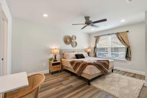 a bedroom with a bed and a ceiling fan at Biloxi Coastal Haven Walk to Beach in Biloxi