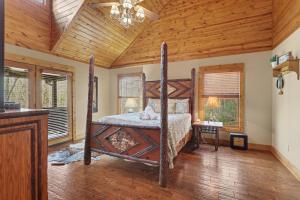 a bedroom with a bed with a wooden ceiling at Vintage Luxury Mountain Cabin, Creekside, King Bed, Spa, Fire Pit, Game Room, DogsOk in Hiawassee