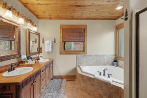 a bathroom with two sinks and a bath tub at Vintage Luxury Mountain Cabin, Creekside, King Bed, Spa, Fire Pit, Game Room, DogsOk in Hiawassee +44 photos