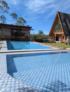 an image of a swimming pool in front of a house at Artana cabin in Palayangan