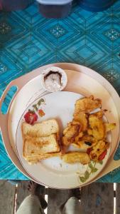 a plate of food with bread and toast on a table at Adefiro homestay in Waisai
