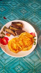 a plate of food with an omelet and vegetables at Adefiro homestay in Waisai
