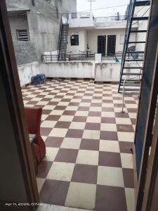 an empty room with a checkered floor and stairs at Guest house one room 9&&&&So&&2 in Kharar