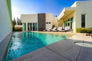 a swimming pool in front of a house at 3BR Luxury Pool Villa, Hua Hin (TP3) in Hua Hin