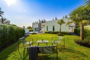 a garden with chairs and a table in front of a house at 3BR Luxury Pool Villa, Hua Hin (TP3) in Hua Hin