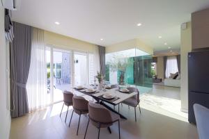 a dining room with a table and chairs in a house at 3BR Luxury Pool Villa, Hua Hin (TP3) in Hua Hin