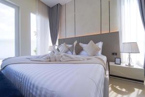 a bedroom with a large white bed with pillows at 3BR Luxury Pool Villa, Hua Hin (TP3) in Hua Hin +48 photos