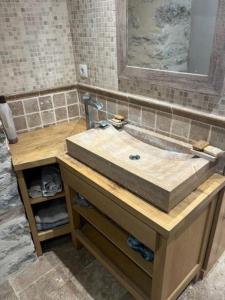 a bathroom with a wooden counter with a sink at L'impasse de la courtasse in Sainte-Énimie