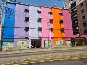 a colorful building on the side of a street at Amant Hotel in Goyang