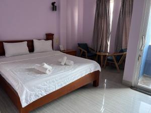 a bedroom with a bed with towels on it at Ocean Breeze Hotel in Kep
