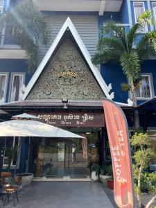 a building with a sign in front of it at Ocean Breeze Hotel in Kep