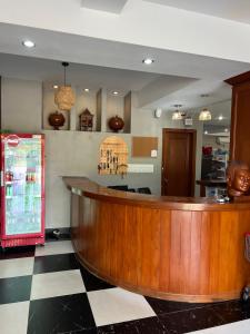 a bar in a restaurant with a checkered floor at Ocean Breeze Hotel in Kep