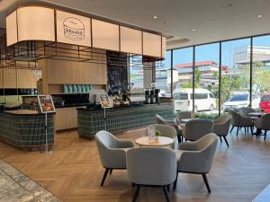 a restaurant with chairs and tables and a counter at Samsara Hotel Pattaya in Pattaya South +120 photos