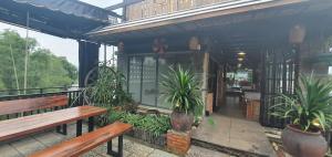 a patio with benches and plants on a building at Hotel Suối Cao in Phú Quốc