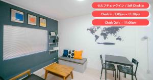 a room with a desk and a world map on the wall at TRANSIT HOSTEL Cafe and Bar in Izumi-Sano