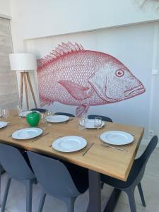 a wooden table with a fish head on the wall at l'Herbo' MAGNIFIQUE maison à 2 pas du port de Pêche in LʼHerbaudière +50 photos