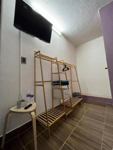 a room with a wall mounted flat screen tv at Alojamiento Artemisa in Mexico City +49 photos