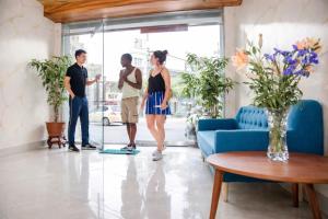 a group of people standing in a living room at Eco Nest Hotel 6 Đình Ngang in Hanoi
