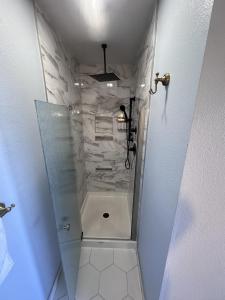 a bathroom with a shower with a glass door at Sugarloaf Mountain Motel in Virginia City +65 photos