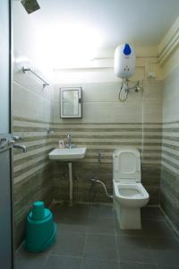 a bathroom with a toilet and a sink at Himavati Retreat in Darjeeling +173 photos