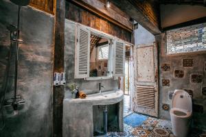 a bathroom with a sink and a mirror at Batukaru Coffee Estate in Tabanan
