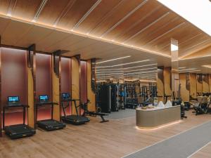 a gym with treadmills and elliptical machines at Fairmont Hanoi in Hanoi